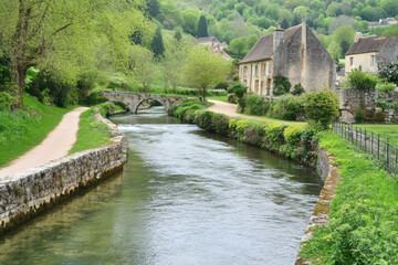Fototapeta premium Scenic river landscape background with stone bridge and buildings
