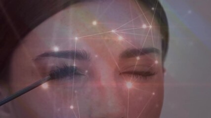 Mascara brush entering model applying mascara for coverage with gliding wand and nodes pulsing