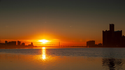Detroit landscape with its suspension bridge - Ambassador Bridge connecting Canada and USA at the sunset in February. 