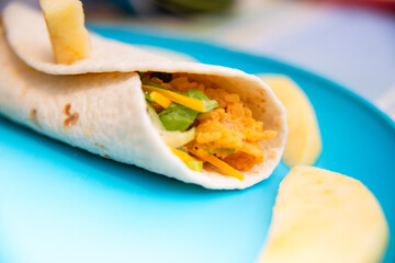 Homemade totilla filled with filling and cheese for kids meal. 