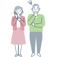 困った表情のシニア夫婦