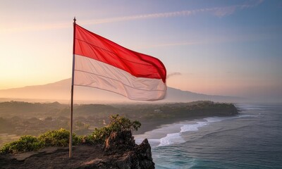National flag waving over coastal landscape at sunrise