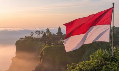 Sunrise over cliffside temple with indonesian flag