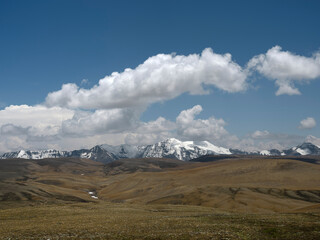 snow mountain under blue sky with white clouds
