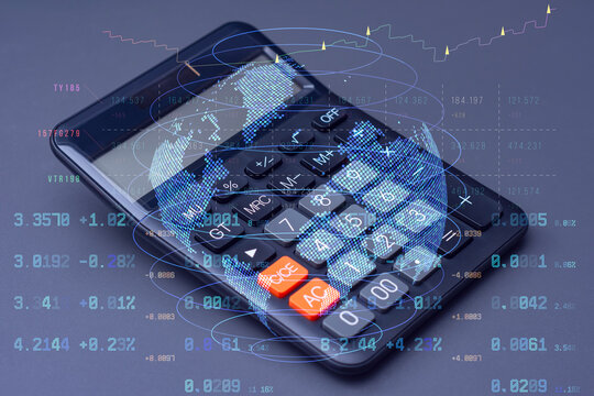Calculator with a digital world map and stock data overlay. Technology concept global finance, trading analytics, and digital economy trends.
