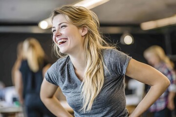 Fototapeta premium Young Woman Laughing in Modern Office - Happy Female Professional Enjoying Teamwork and Work Environment