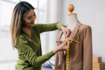 Fashion designer measuring garment on mannequin in bright studio