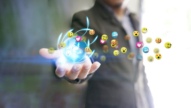 n\businessman Holding Globe with Floating Emojis