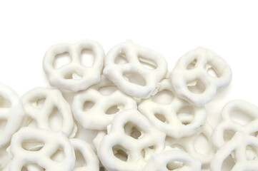 White chocolate covered pretzels on white background 