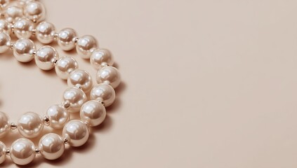 Fototapeta premium Two pearl necklaces on a pale beige surface