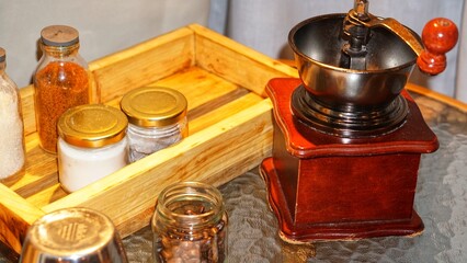 View of vintage coffee grinder and beans on countertop in kitchen. Coffee brew. Mill