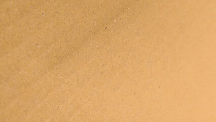 Brown color paper shown grain details on  it surface. High resolution seamless yellow cardboard background.