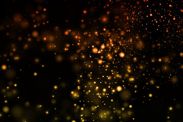Obraz premium Golden and orange bokeh lights against a dark background, creating a warm atmosphere.