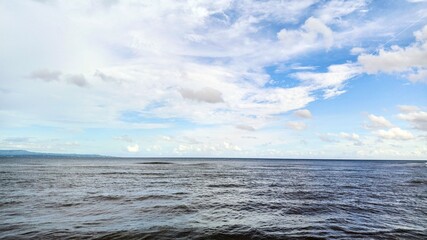 Vast Ocean Under Cloudy Sky