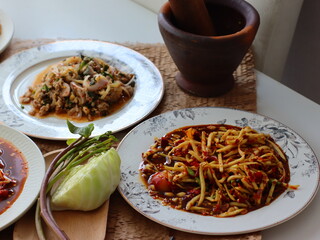 Som Tum — a vibrant and spicy Thai green papaya salad made with shredded unripe papaya, garlic, chili, lime juice, fish sauce, and palm sugar. This iconic street food dish from Thailand .