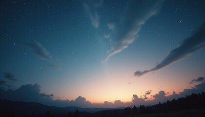 Obraz premium Serene sunset over mountains with stars and clouds