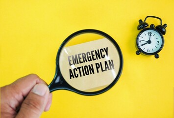Alarm clock and magnifying glass with the word emergency action plan. plan for emergencies