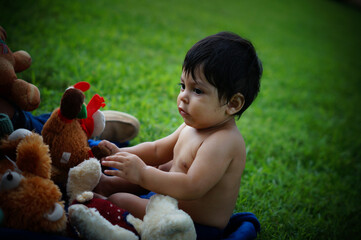 Mexican baby outside with toys