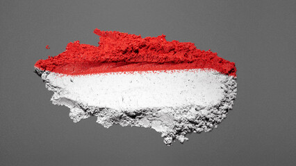 Closeup view of the red and white colors of the Indonesian national flag with a black wall...