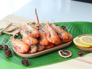 Grilled river prawns — a premium Thai seafood dish featuring large freshwater prawns grilled over charcoal until the shells are slightly charred and the head fat turns golden. Served with spicy Thai s