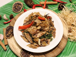 Stir-fried mackerel with Thai basil — a flavorful Thai home-style dish made with fried short mackerel (Pla Too), stir-fried with garlic, chili, and fresh holy basil leaves. Rich in aroma and spicy fla