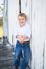 Portrait of happy little boy smiling on farm
