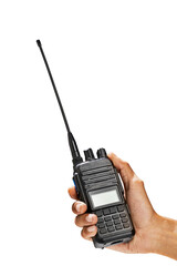 Closeup view of a human hand holding a black walkie talkie radio communication device isolated over a white background