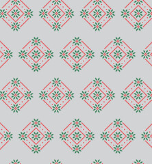A modern take on traditional folk art, this seamless pattern combines geometric snowflakes and floral elements in a festive red and green color palette, perfect for backgrounds and textiles.