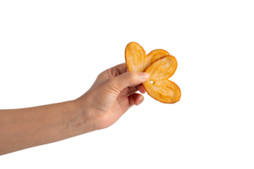 Heart shaped sugared crackers in hand on transparent background