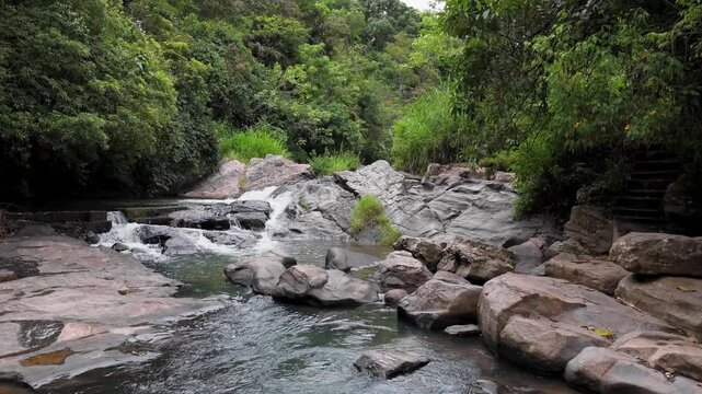 Drone Zoom-In Shot of Small Waterfall in Tropical Forest Sri Lanka