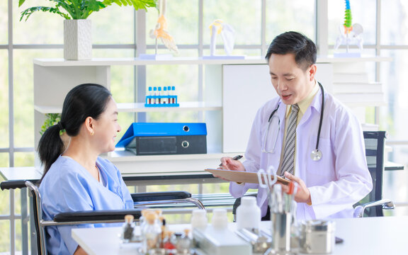 Asian male doctor in white coat with stethoscope, consulting explain medications to senior female patient professional support trust healthcare checkup, insurance treatment wellness in hospital 
