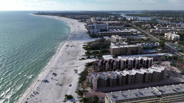warm waves from the Gulf of Mexico waters lap on the beautiful white sand beaches of Siesta Key beach, Florida