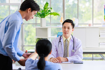 Obraz premium Asian professional doctor consulting senior old female patient with caregiver beside in bright medical office checkup insurance attentively reviews health details care support examination healthcare