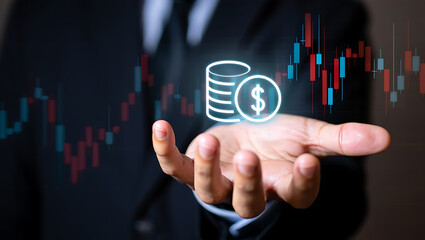 Hand holding glowing coins with financial chart money