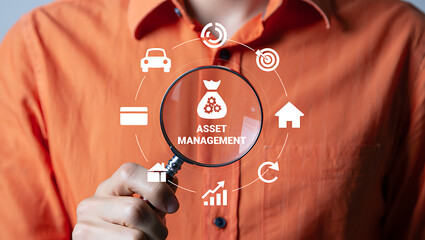 Magnifying glass over asset management icons credit card