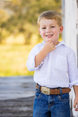 Portrait of happy little boy smiling on farm
