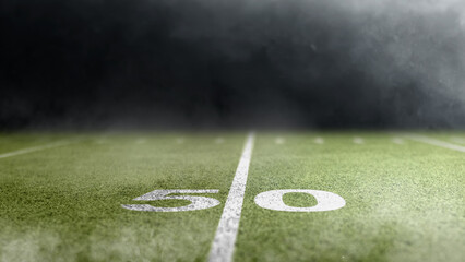 Fifty yard line on the turf of an American football green field stadium