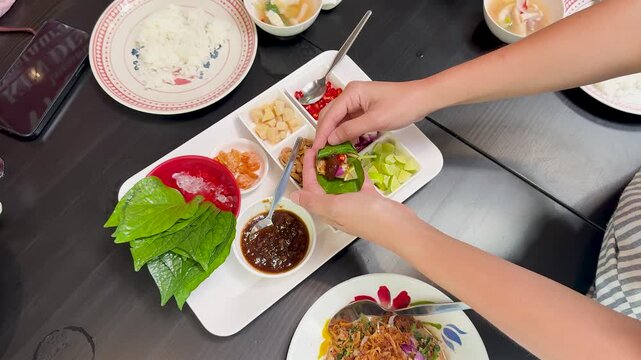 Preparing Miang Kham Savory Leaf Wraps at Dining Table
