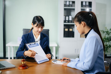 Professional female lawyers consulting on legal cases in a modern office. Perfect for law, business, justice