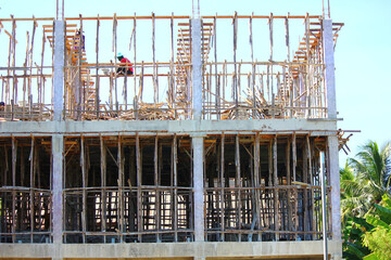 construction worker preparing wooden support structure before pouring concrere beam