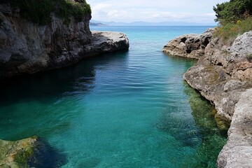Clear turquoise water channel between rocky cliffs