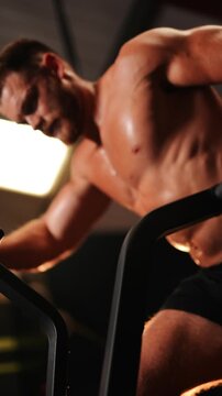 A man is working out on a treadmill. He is smiling and he is enjoying himself. Concept of positivity and motivation, as the man is actively engaging in physical activity and taking care of his health