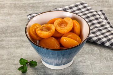 Sweet canned apricots with syrope
