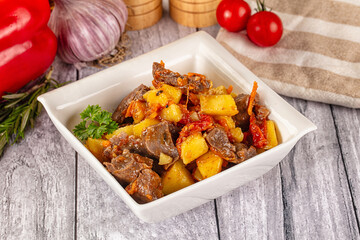 Rogiut with meat, potato and tomatoes