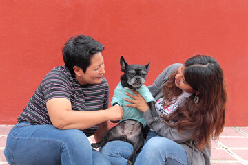 Couple of two brunette Latina lesbians show their love for the dog that is their pet and part of their family