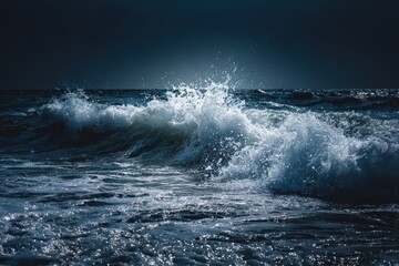Fototapeta premium Dark blue ocean waves crash against the shore at night, illuminated by the moonlight and reflecting shimmering white foam on the surface