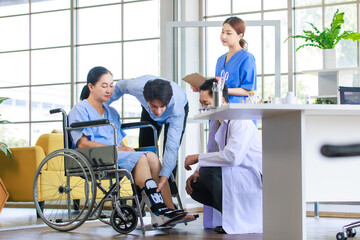 Asian doctor physiotherapy check splint leg support to senior old woman patient assisted by caregiver and nurse medical orthopedic trauma treatment team providing rehabilitation in a healthcare clinic