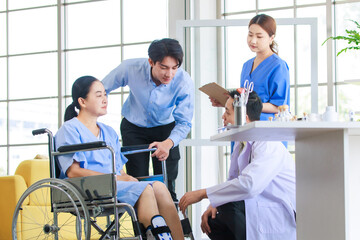 Fototapeta premium Asian doctor physiotherapy check splint leg support to senior old woman patient assisted by caregiver and nurse medical orthopedic trauma treatment team providing rehabilitation in a healthcare clinic