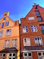 beautiful medieval houses , colorful, street of an old europenean town, blue sky