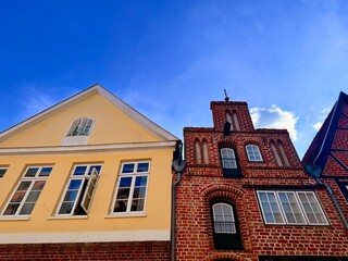 beautiful medieval houses , colorful, street of an old europenean town, blue sky